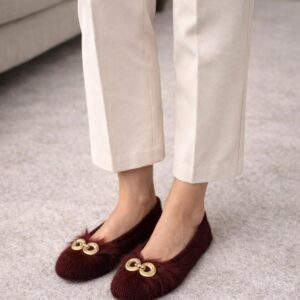 Burgundy knit slippers with fur trim and gold chain detail