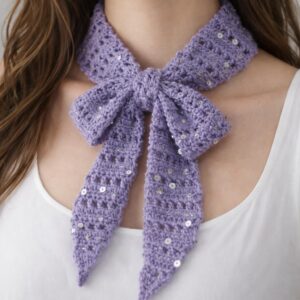 Lavender crochet bow neck scarf with subtle sequins tied around the neck