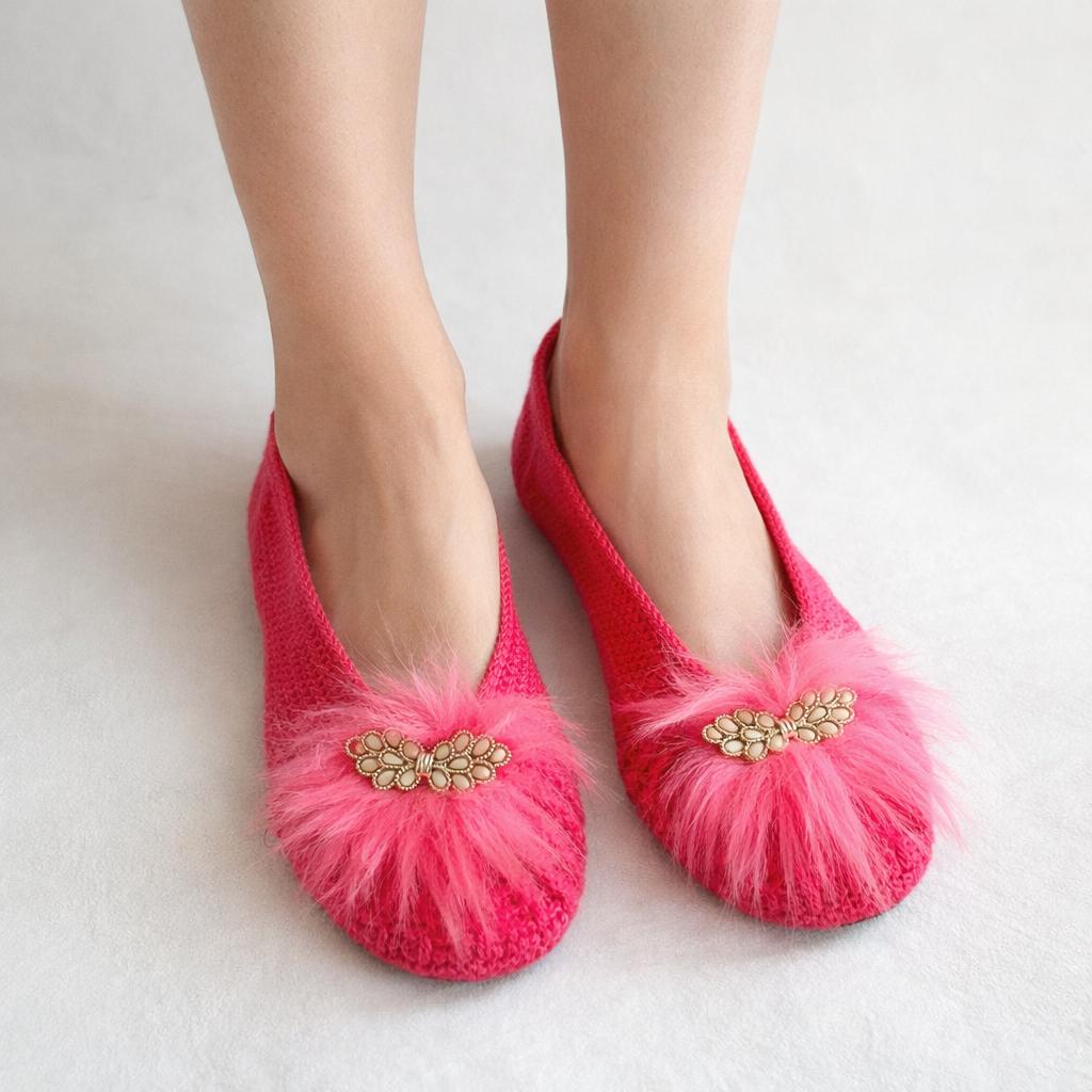 Hot pink hand-knit ballet slippers with fluffy faux-fur pom and gold butterfly detail